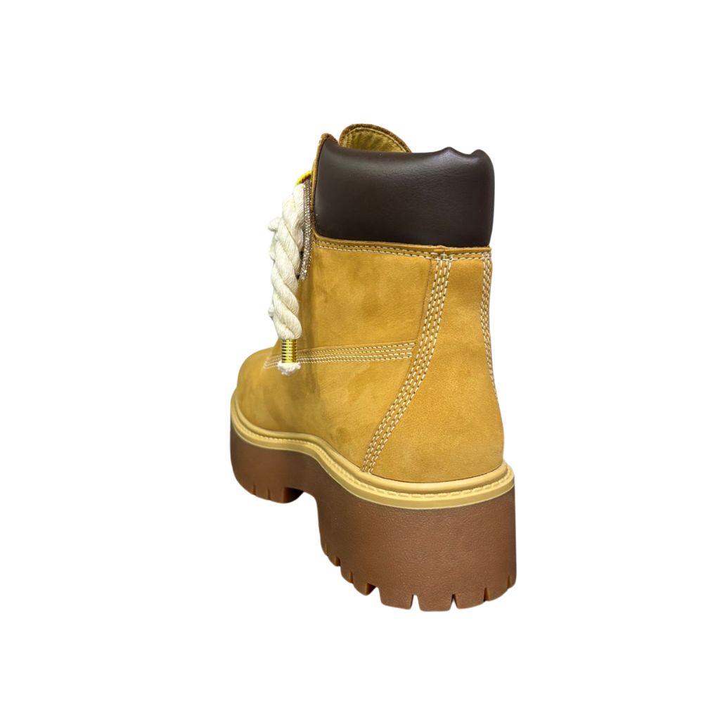Stivale Timberland platform in nubuck color miele con lacci a corda bianchi, occhielli dorati e suola carrarmato marrone.