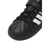 Sneakers adidas nere da bambino con tre strisce bianche e strappo