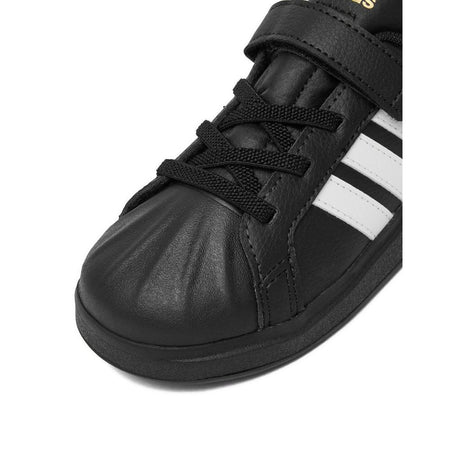 Sneakers adidas nere da bambino con tre strisce bianche e strappo