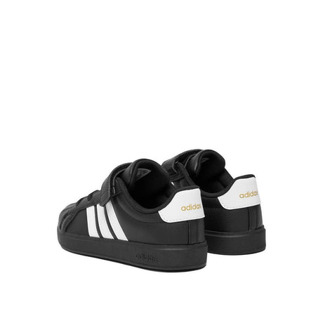 Sneakers adidas nere da bambino con tre strisce bianche e strappo