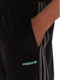 Pantaloni Adidas neri in velluto a coste con bande grigie laterali