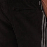 Pantaloni Adidas neri in velluto a coste con bande grigie laterali