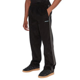 Pantaloni Adidas neri in velluto a coste con bande grigie laterali