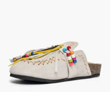 Mule Gagliotta in camoscio ghiaccio con frange, perline multicolor e laccetti colorati, suola sughero 4 cm.
